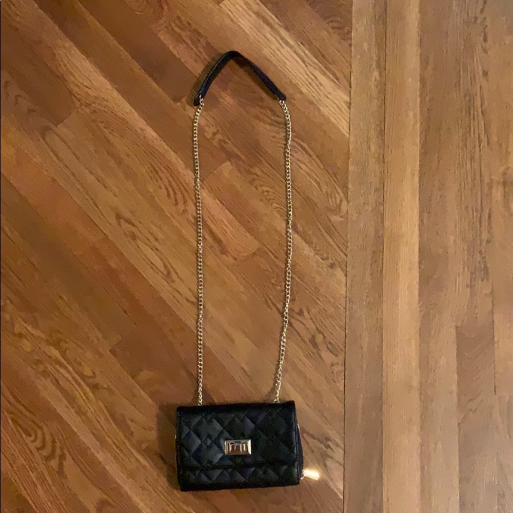 Black purse with gold metal straps and accents